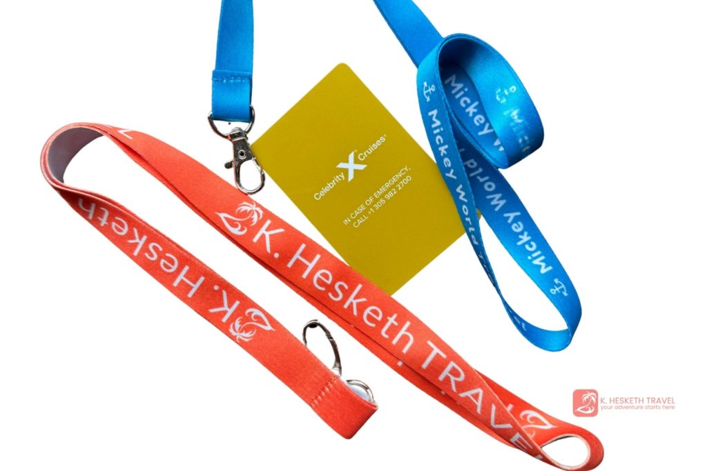 An orange lanyard and a blue lanyard lay on a white background with a Celebrity Cruise sail card.